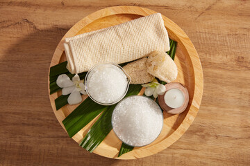 Close view of salt in spa decorated with towel and candles in wooden tray for exfoliating advertise , top view
