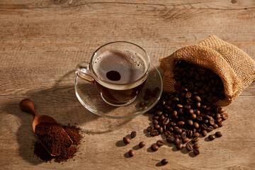 A closeup view of coffee decorated with coffee pack in wooden background for advertising 