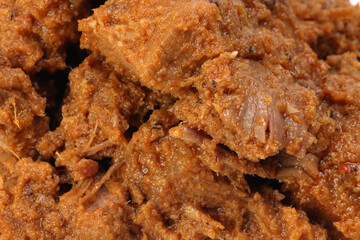 Traditional cooked beef meat rendang dry curry closeup
