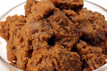 Traditional cooked beef meat rendang dry curry closeup