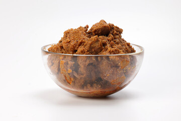 Traditional cooked beef meat rendang dry curry closeup in transparent glass bowl