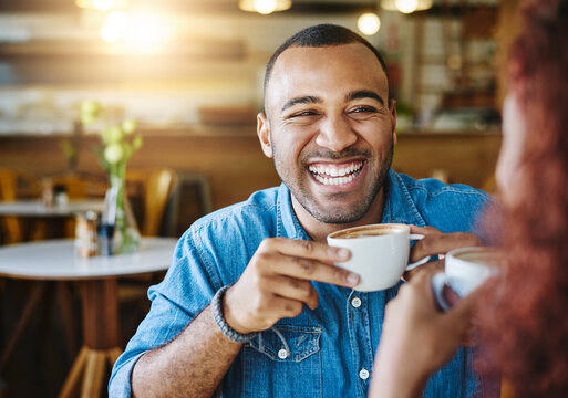 He loves spending time with her. Cropped shot of a handsome young man spending time with his girlfriend in a coffee shop. - Powered by Adobe