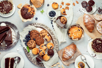 Dessert table with all kinds snacks on light background.
