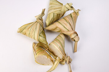 Traditional diamond shaped woven palm leaf pouch steamed glutenous rice cake ketupat kupat tipat on white background