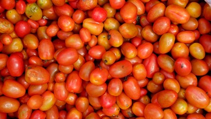 Stacked tomatoes cherry in traditional market, tomatoes cherry background 
