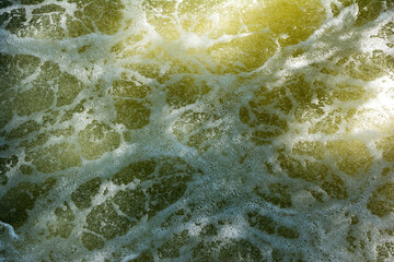 River water bubbles surface background with sunlight