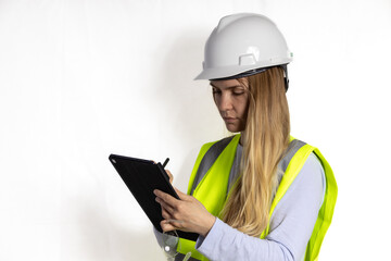 female construction worker. writing on tablet computer
