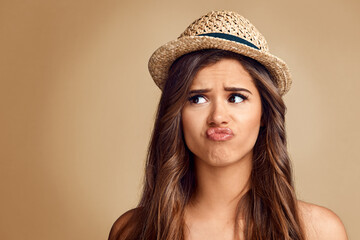 You dont have to be weird about it. Studio shot of a beautiful young woman looking thoughtful against a brown background.