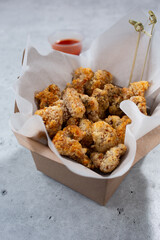 A view of a carton of popcorn chicken.