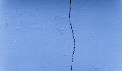 Background wall with paint that begins to peel off with age. Cracked wall, paint