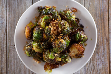 A top down view of a plate of grilled Brussels sprouts.
