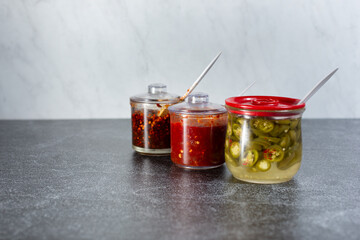A view of a few condiment jars often seen at local Vietnamese restaurant.