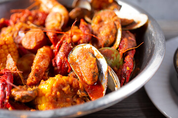 A closeup view of a metal bowl of crawfish boil.