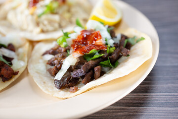 A closeup view of a plate of carne asada street tacos.