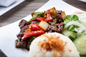 A view of a plate of shaking beef.