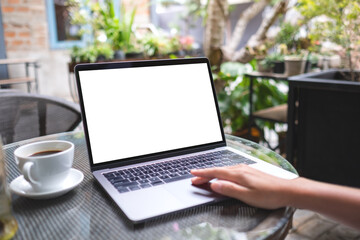 Mockup image of a woman using and typing on laptop computer with blank white desktop screen