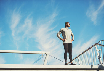 Working out is a reward, not a punishment. Shot of a young sporty man standing outside.