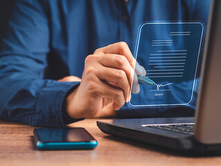 A businessman using a pen signing electronic documents on digital documents on a virtual screen