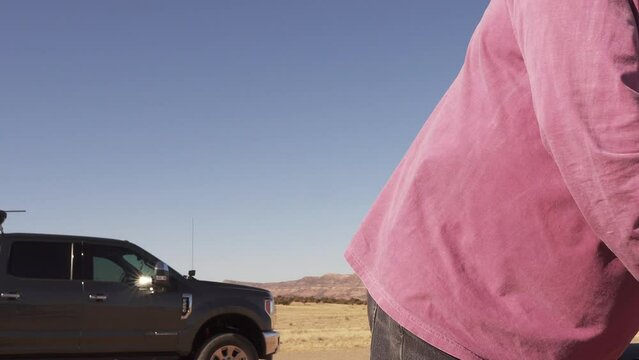 Man clears his rifle at the shooting range and places it down.