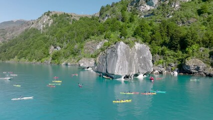 Kayakers Exploring Marble Chapel Caves On Lake General Carrera. Aerial Circle Dolly
