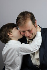 father and son cheek kiss