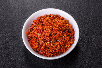 Paprika spice with smoked tomatoes crushed in a white saucer