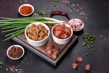 Snacks, jerky for beer on a black stone background