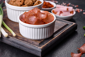Snacks, jerky for beer on a black stone background