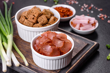 Snacks, jerky for beer on a black stone background