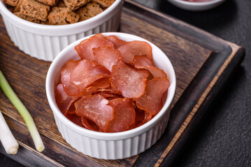 Snacks, jerky for beer on a black stone background
