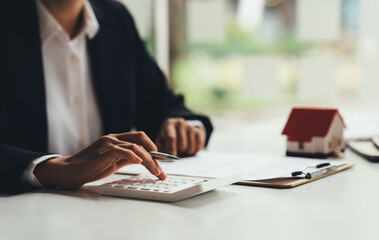 The real estate agent is explaining the house style to the clients who come to contact to see the...