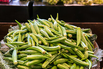 Pile of fresh green okra in farmers market - obrazy, fototapety, plakaty