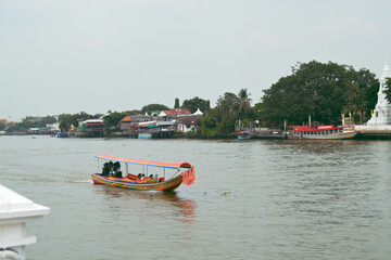 Fototapeta na wymiar Tourists on a longtail boat visit Koh Kret. The Thai tourist attraction is famous of the Nonthaburi, Thailand.