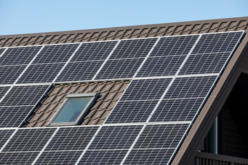 Solar panels on brown metal roof. Environmentally and energy saving