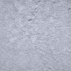 The wall is covered with gray decorative plaster