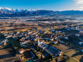 Central Friuli villages seen from above. Between hills and snow-capped mountains. Raspano di...