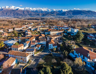 Central Friuli villages seen from above. Between hills and snow-capped mountains. Martinazzo of...
