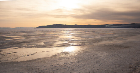 Obraz premium Horizontal banner. Frozen lake. Sunset. Globetrotting. Adventure. Mountains.Winter.