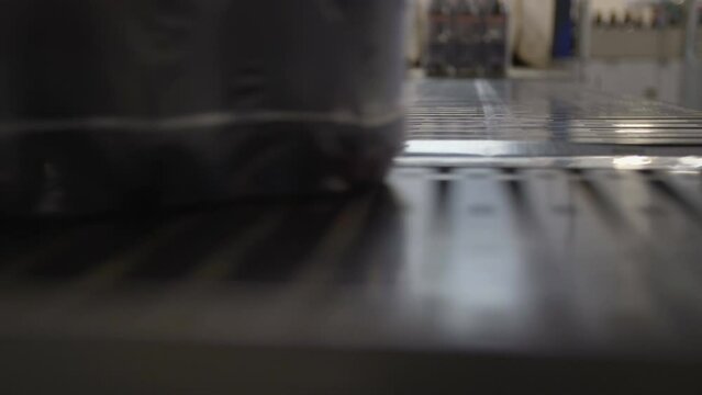 Packing with butyl bottles goes around the conveyor.