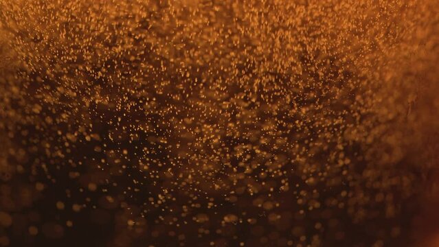 Close-up of the contents of a glass of beer Beer bubbles inside the glass, waves, bubbles and foam.