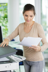 woman makes photocopies in office