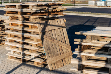 Empty pallets at a construction site. Reuse of wooden pallets in construction.