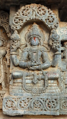 Fototapeta na wymiar Sculpture of Meditating Vishnu, Lakshminarsimha Temple, Javagal , Hassan, Karnataka, India