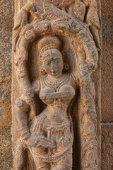 Fototapeta na wymiar Carved scuplture of woman on entrance gate of Someshwara Temple, Kolar, Karnataka, India