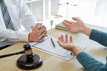 Law consultancy concept A male client explaining some confusing detail of the contract to the...