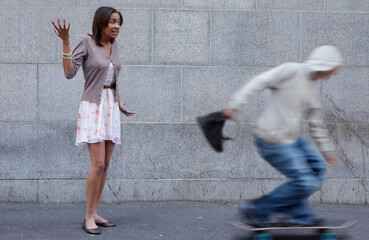 Hey, thats mine. Young woman having her bag snatched by a criminal on a skateboard.