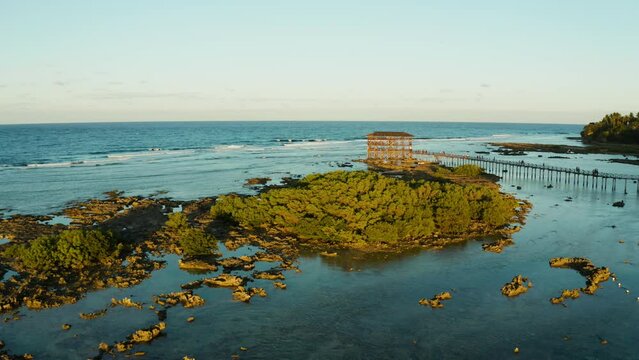 Aerial view of wooden walkway for surfers to cross the reef of siargao island to cloud 9 surfspot. Summer and travel vacation concept
