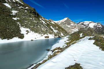 Panoramic view on the mountains of High Tauern Alps in Carinthia and Salzburg, Austria, Europe. Glacier lakes of the Goldbergkees in the Hohe Tauern National Park. Hoher Sonnblick. Snow