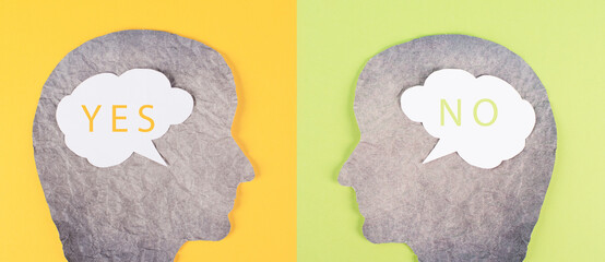 Head silhouettes with speech bubbles, words yes and no, communication between people, business and...