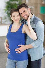 Fototapeta premium man hugging the belly of pregnant woman